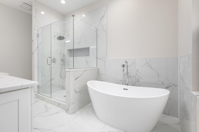 223 Center St, Naperville, IL 60540 - full bathroom with marble tiled floors, a marble finish shower, tile walls, vanity, and a freestanding bath