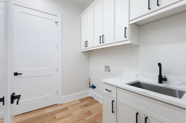 223 Center St, Naperville, IL 60540 - laundry room featuring washer hookup, light wood-type flooring, and cabinet space