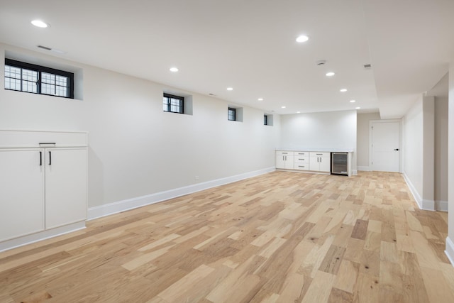 223 Center St, Naperville, IL 60540 - below grade area featuring beverage cooler, light wood-type flooring, recessed lighting, and bar