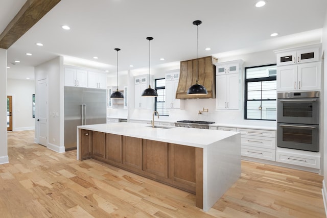 223 Center St, Naperville, IL 60540 - kitchen with appliances with stainless steel finishes, custom range hood, light wood-type flooring, light countertops, and recessed lighting