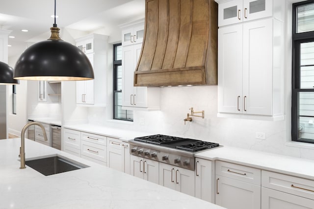 223 Center St, Naperville, IL 60540 - kitchen featuring stainless steel gas cooktop, premium range hood, decorative backsplash, white cabinets, and pendant lighting