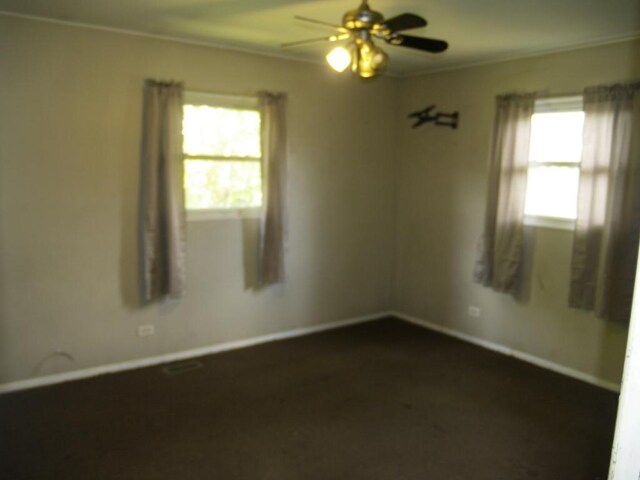 22340 Chappel Ave, Sauk Village, IL 60411 - spare room with a ceiling fan, crown molding, and dark carpet