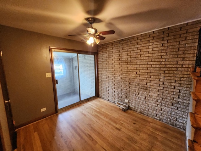 9201 S Kedzie Ave Unit 3, Evergreen Park, IL 60805 - unfurnished room featuring ceiling fan, wood finished floors, and brick wall