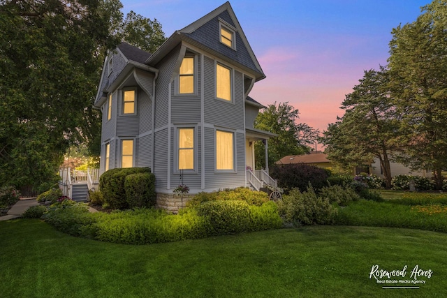 217 N Maple St, Momence, IL 60954 - back of property at dusk featuring a yard