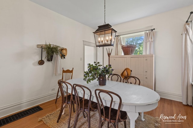 217 N Maple St, Momence, IL 60954 - dining room featuring a chandelier and wood finished floors