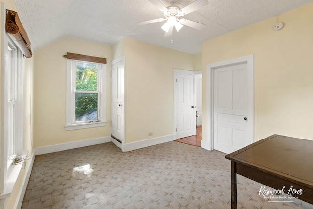 217 N Maple St, Momence, IL 60954 - unfurnished bedroom featuring carpet flooring, lofted ceiling, and a ceiling fan