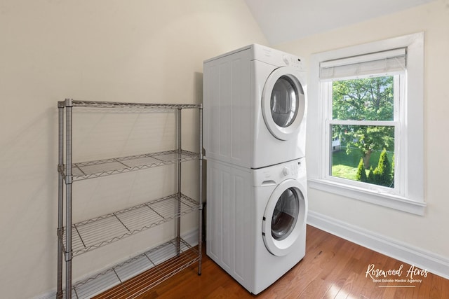 217 N Maple St, Momence, IL 60954 - washroom with stacked washer and clothes dryer, healthy amount of natural light, and wood finished floors