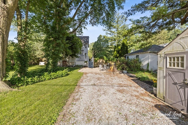 217 N Maple St, Momence, IL 60954 - view of green lawn featuring a patio and a storage unit