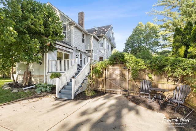 217 N Maple St, Momence, IL 60954 - view of property exterior with a patio area, a chimney, a gate, and a deck
