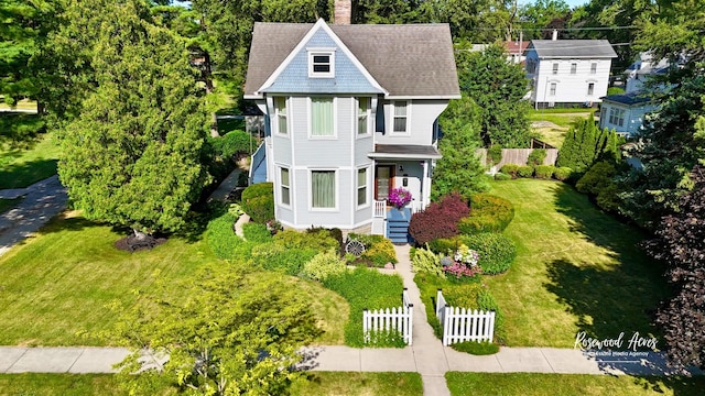 217 N Maple St, Momence, IL 60954 - view of front facade featuring a chimney, view of scattered trees, and a shingled roof