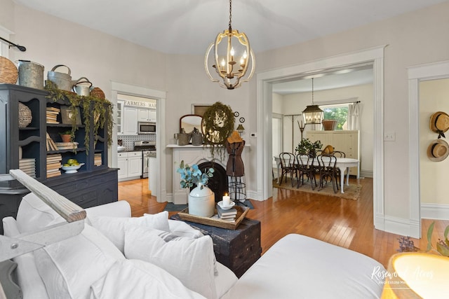 217 N Maple St, Momence, IL 60954 - living room with a chandelier and light wood-style flooring