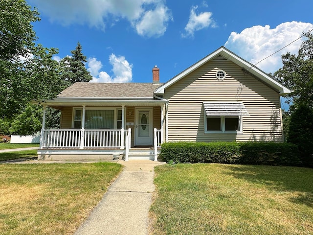 919 S Vermillion St, Streator, IL 61364 - view of front of house featuring covered porch, a front lawn, a chimney, and roof with shingles