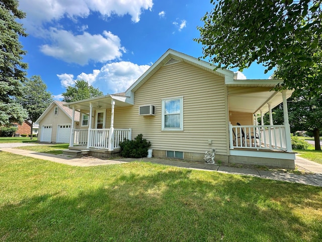 919 S Vermillion St, Streator, IL 61364 - view of front of house with a porch, a front yard, a wall unit AC, and a garage