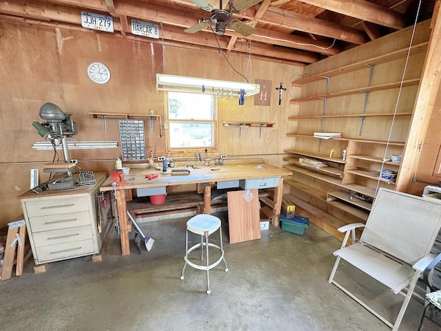 919 S Vermillion St, Streator, IL 61364 - miscellaneous room with a workshop area, concrete flooring, a ceiling fan, and wood walls