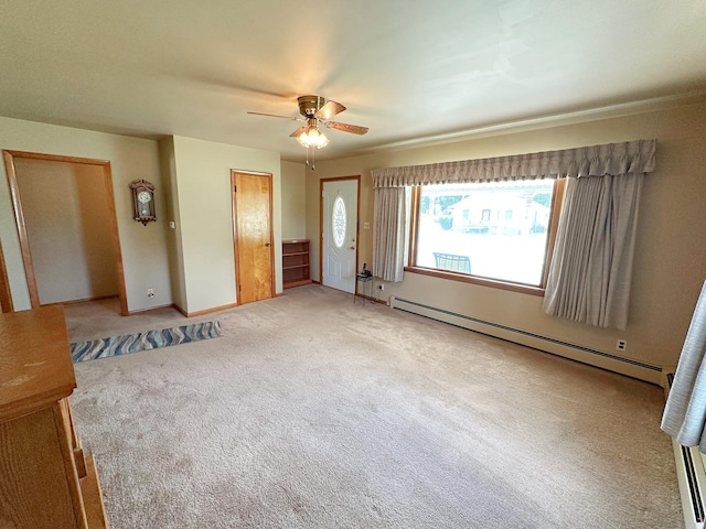 919 S Vermillion St, Streator, IL 61364 - entrance foyer featuring a baseboard heating unit, ceiling fan, and light colored carpet