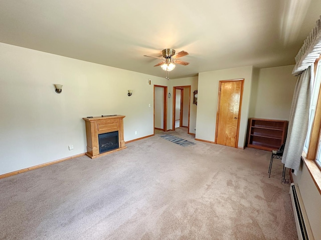 919 S Vermillion St, Streator, IL 61364 - unfurnished living room with a baseboard radiator, light carpet, a glass covered fireplace, and a ceiling fan
