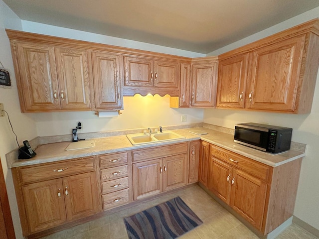 919 S Vermillion St, Streator, IL 61364 - kitchen with stainless steel microwave, light countertops, and light tile patterned floors