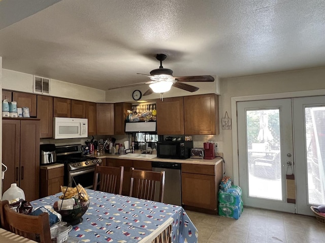 8212 Cameo Dr, Machesney Park, IL 61115 - kitchen with appliances with stainless steel finishes, light countertops, ceiling fan, a textured ceiling, and french doors