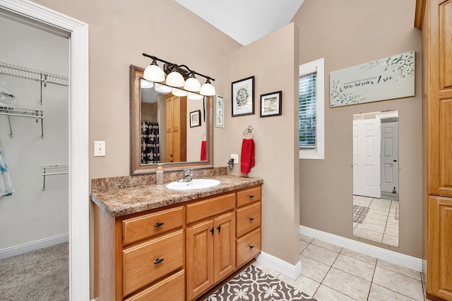 300 Village Ln, Seneca, IL 61360 - full bathroom featuring vanity, tile patterned floors, a spacious closet, and vaulted ceiling