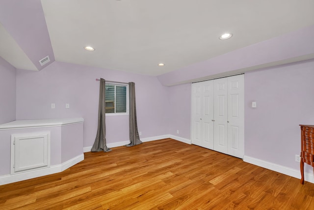 300 Village Ln, Seneca, IL 61360 - unfurnished bedroom featuring light wood-style floors, recessed lighting, a closet, and lofted ceiling