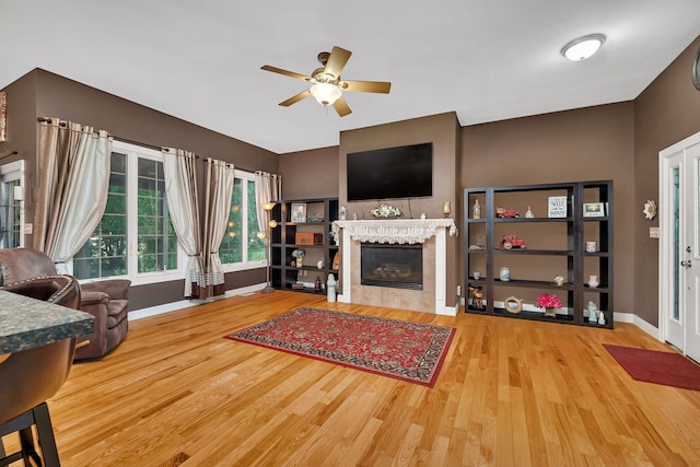 300 Village Ln, Seneca, IL 61360 - living area with wood finished floors, ceiling fan, and a tiled fireplace
