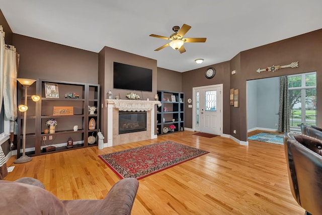 300 Village Ln, Seneca, IL 61360 - living area with a tile fireplace, a ceiling fan, wood finished floors, and healthy amount of natural light