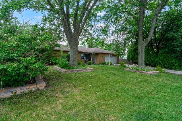 16000 Long Ave, Oak Forest, IL 60452 - view of front of home featuring a front yard, an attached garage, and brick siding