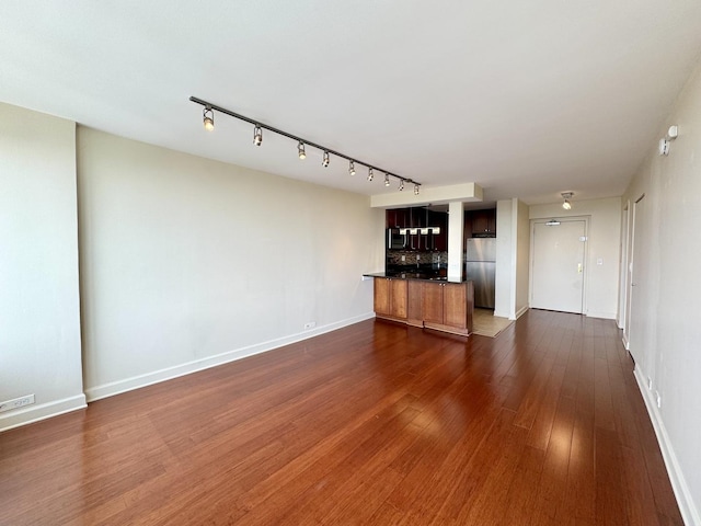 1850 N Clark St Unit 2706, Chicago, IL 60614 - unfurnished living room with dark wood-type flooring and track lighting