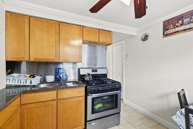 2730 N 74th Ct Unit Gw, Elmwood Park, IL 60707 - kitchen with gas stove, light tile patterned flooring, a ceiling fan, dark stone countertops, and crown molding