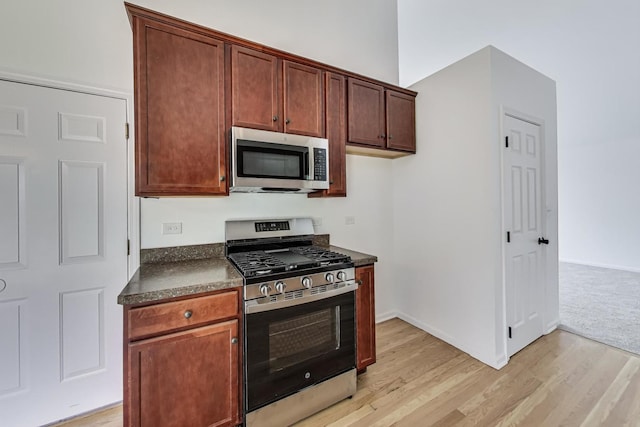 25651 S Middle Point Ave, Monee, IL 60449 - kitchen with appliances with stainless steel finishes, dark countertops, and light wood-style floors