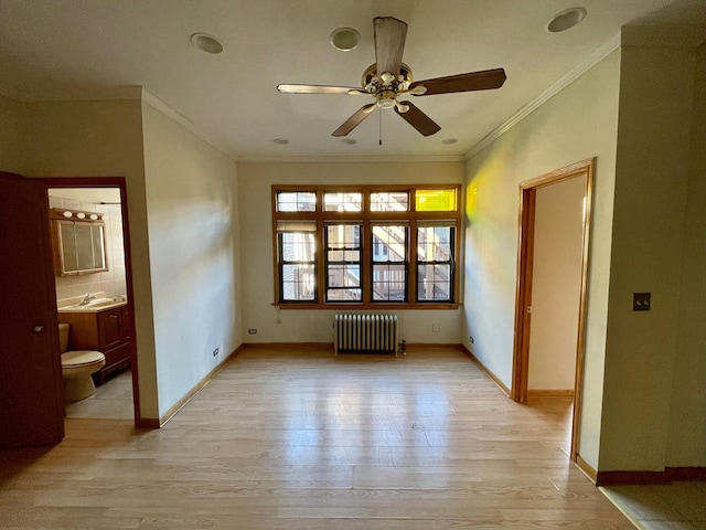 1127 W Farwell Ave Unit 106, Chicago, IL 60626 - spare room with radiator, ornamental molding, light wood-style flooring, and a ceiling fan