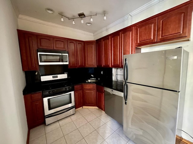1127 W Farwell Ave Unit 106, Chicago, IL 60626 - kitchen featuring appliances with stainless steel finishes, light tile patterned flooring, dark countertops, ornamental molding, and reddish brown cabinets