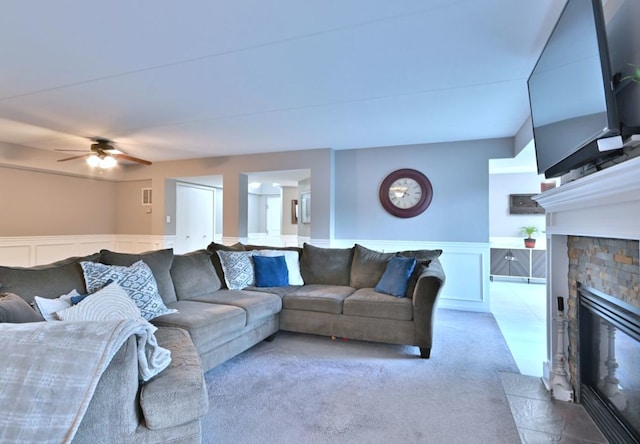 14031 Norwich Ln Unit 101, Orland Park, IL 60467 - carpeted living area with a decorative wall, a fireplace, wainscoting, and a ceiling fan