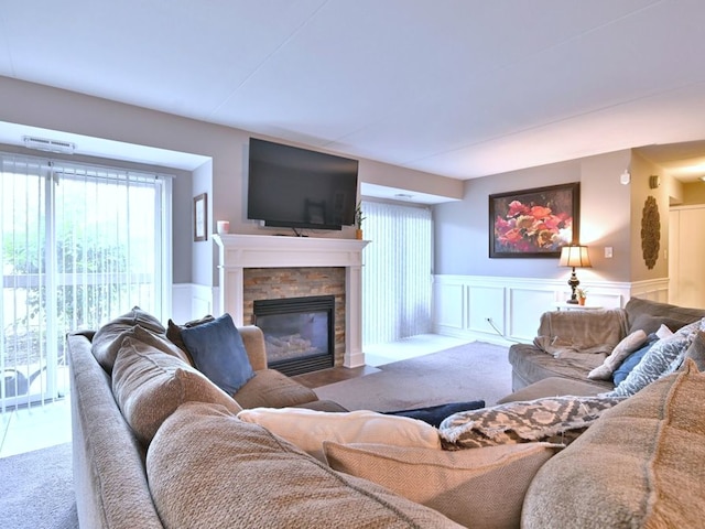 14031 Norwich Ln Unit 101, Orland Park, IL 60467 - living area with a fireplace, carpet, wainscoting, and a decorative wall