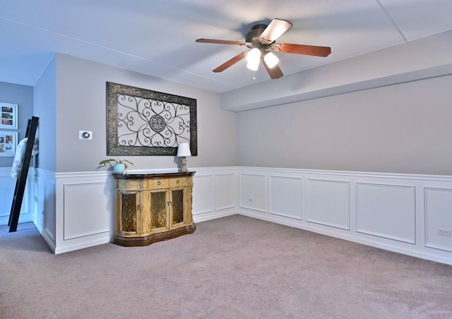 14031 Norwich Ln Unit 101, Orland Park, IL 60467 - unfurnished living room with carpet flooring, a ceiling fan, wainscoting, and a decorative wall