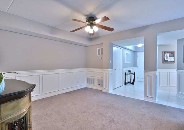14031 Norwich Ln Unit 101, Orland Park, IL 60467 - unfurnished room with light carpet, a ceiling fan, wainscoting, and a decorative wall