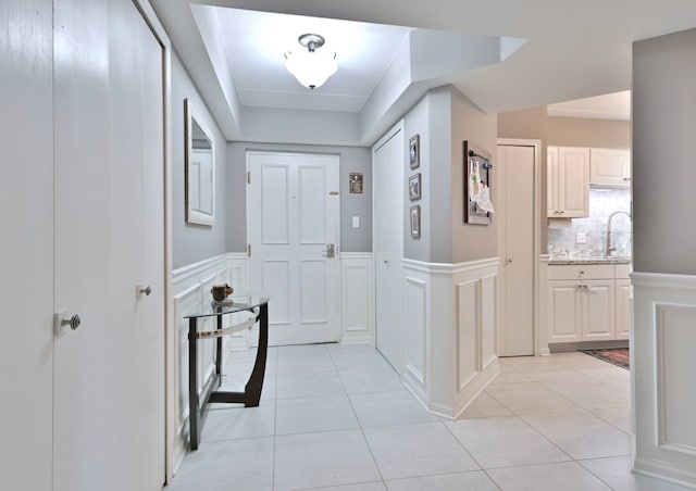 14031 Norwich Ln Unit 101, Orland Park, IL 60467 - hallway with a decorative wall, wainscoting, and light tile patterned floors