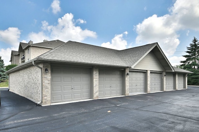 14031 Norwich Ln Unit 101, Orland Park, IL 60467 - view of side of property with community garages and a shingled roof