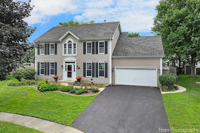 768 Wexford Ct, Grayslake, IL 60030 - colonial inspired home with an attached garage, asphalt driveway, a front lawn, and roof with shingles