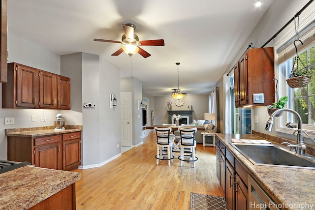 768 Wexford Ct, Grayslake, IL 60030 - kitchen featuring ceiling fan, open floor plan, light wood-style flooring, light countertops, and lofted ceiling