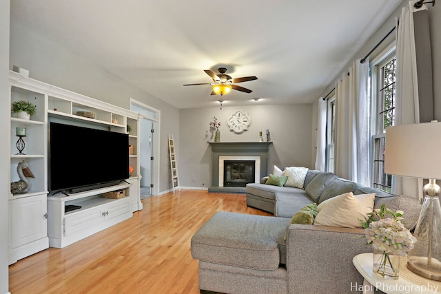 768 Wexford Ct, Grayslake, IL 60030 - living area with light wood finished floors, a brick fireplace, and ceiling fan