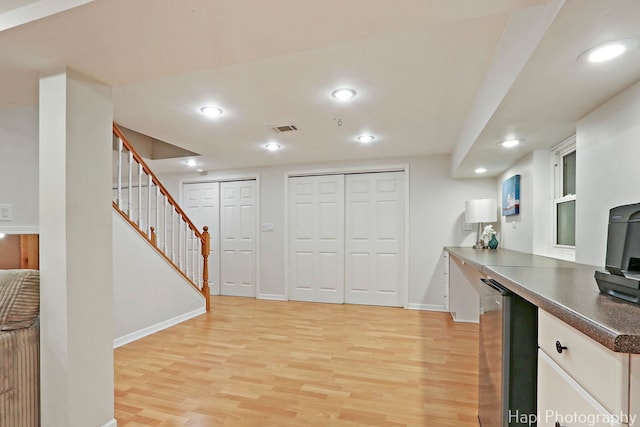 768 Wexford Ct, Grayslake, IL 60030 - kitchen with light wood-type flooring, recessed lighting, dark countertops, white cabinetry, and fridge