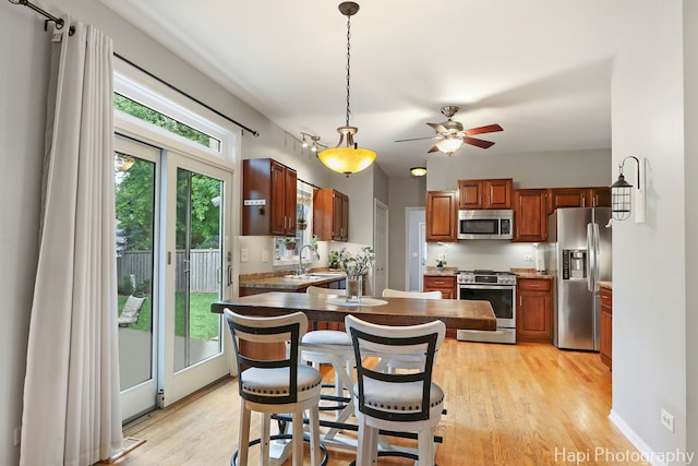 768 Wexford Ct, Grayslake, IL 60030 - kitchen featuring stainless steel appliances, a ceiling fan, decorative light fixtures, and light wood-style flooring