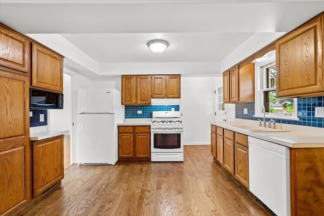 115 S Hale St, Palatine, IL 60067 - kitchen with white appliances, under cabinet range hood, brown cabinetry, wood finished floors, and tasteful backsplash