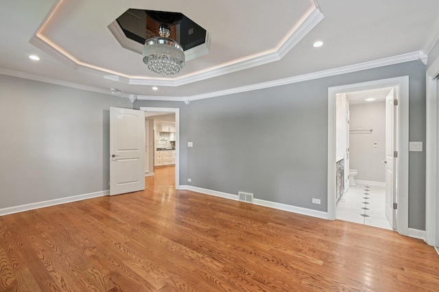 129 Kainer Ave, Barrington, IL 60010 - unfurnished room with a tray ceiling, ornamental molding, light wood finished floors, recessed lighting, and a chandelier