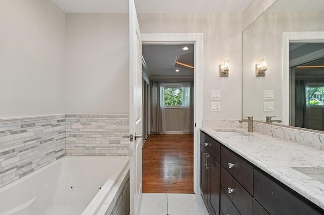 129 Kainer Ave, Barrington, IL 60010 - full bathroom with double vanity, a whirlpool tub, and marble look tiles