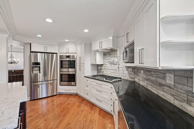 129 Kainer Ave, Barrington, IL 60010 - kitchen with appliances with stainless steel finishes, open shelves, white cabinets, a chandelier, and decorative backsplash