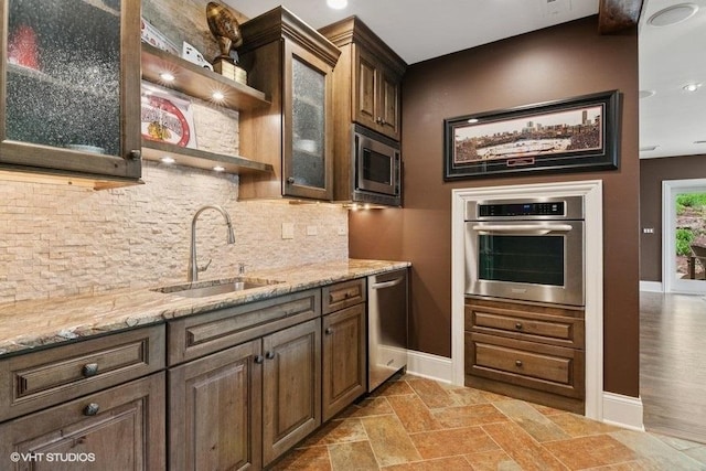 41W590 Bowgren Dr, Campton Hills, IL 60119 - kitchen with appliances with stainless steel finishes, tasteful backsplash, glass insert cabinets, light stone countertops, and open shelves