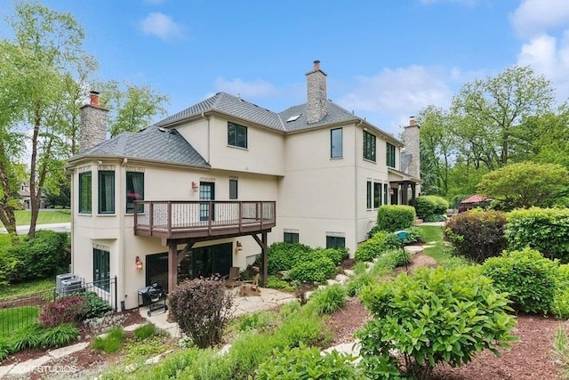41W590 Bowgren Dr, Campton Hills, IL 60119 - back of house featuring stucco siding, a chimney, a patio area, and a wooden deck