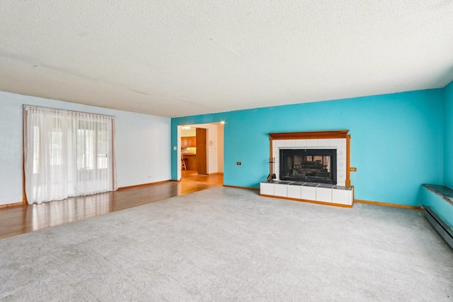 602 Daisy Ln, Round Lake Beach, IL 60073 - unfurnished living room with carpet, a textured ceiling, and a tile fireplace